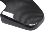 Close-up texture of BMW F9X G8X carbon fibre seat back panel - gloss finish detail