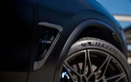 Installed BMW X4M carbon fibre side vent with M emblem on vehicle, showing OEM fitment and aerodynamic upgrade