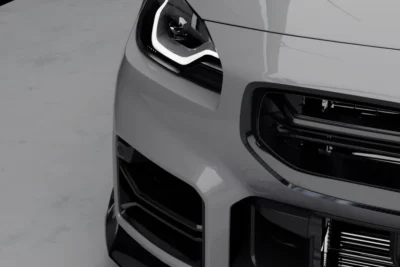 Detail close-up of carbon fibre duct outlet corner on BMW G87 M2 bumper