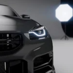 Headlight and intake grille close-up showing BMW G87 M2 carbon fibre ducts