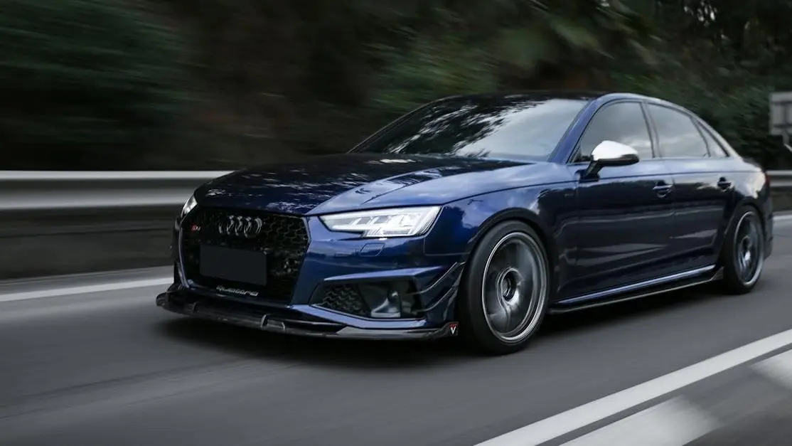 Sleek blue sports car on highway, highlighting improving car aerodynamics and powerful performance.