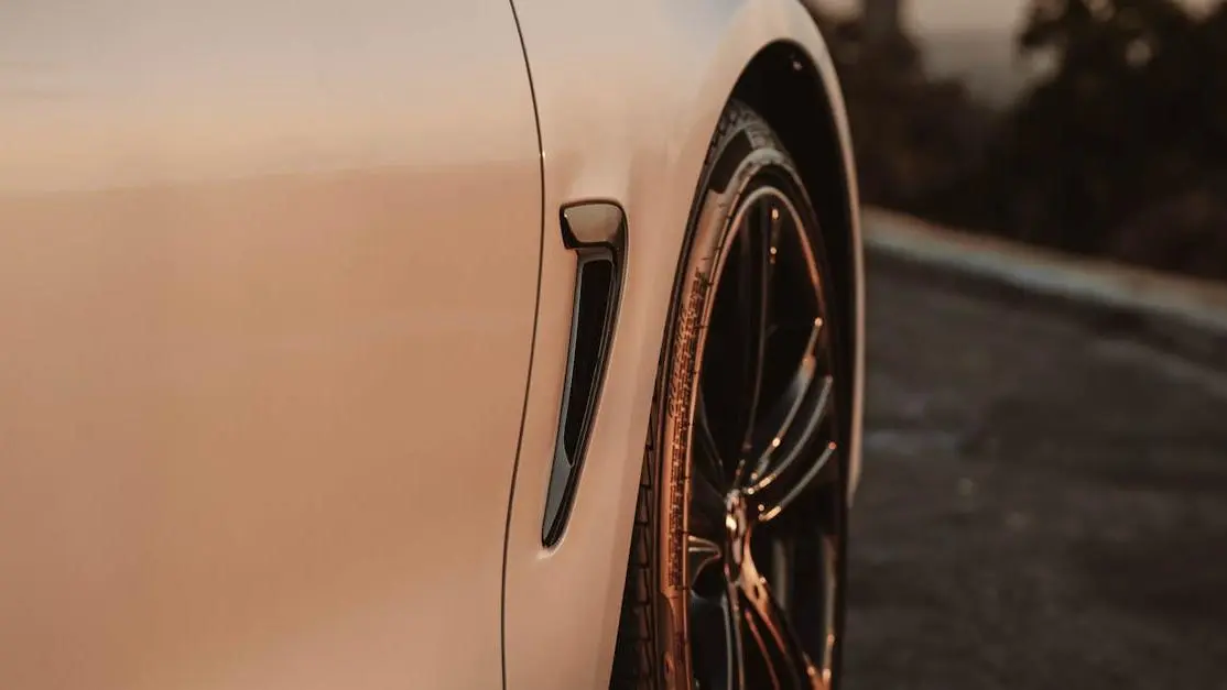 Luxury Car Wheel At Sunset Highlighting Best Performance Tires For Daily Driving