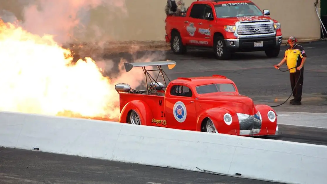 Dragster demonstrating launch control vs 2 step with flames at speedway during race