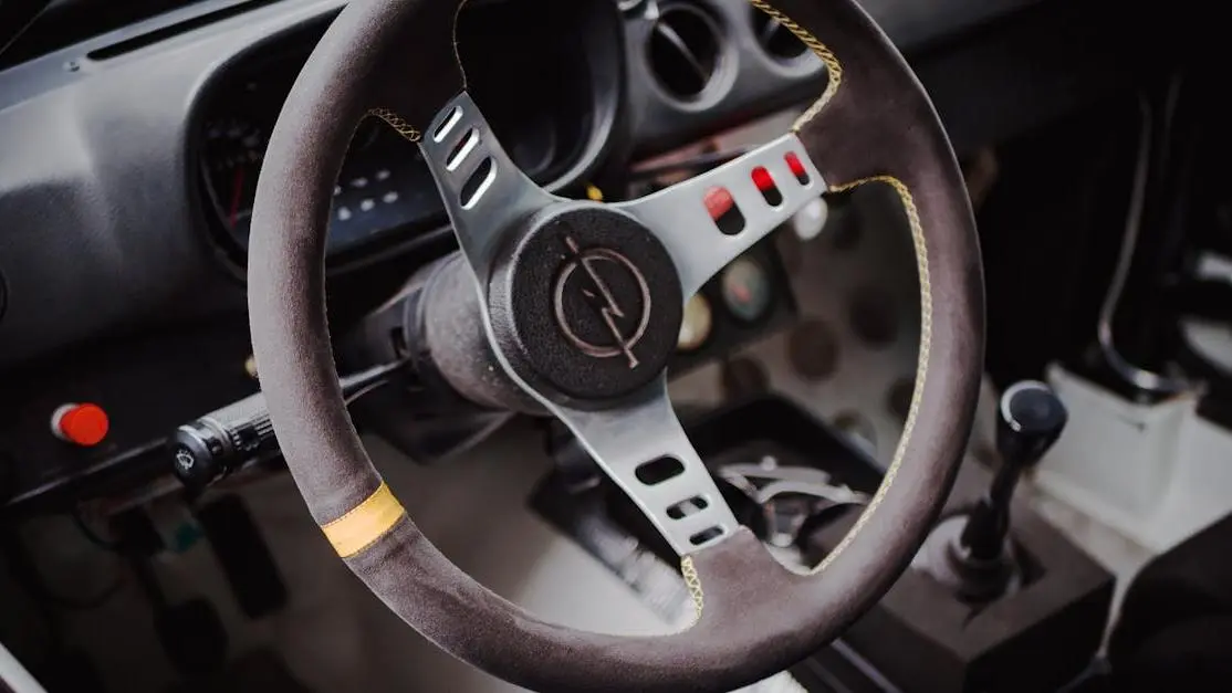Racer steering wheel with dashboard controls, highlighting precision engineering and racing design
