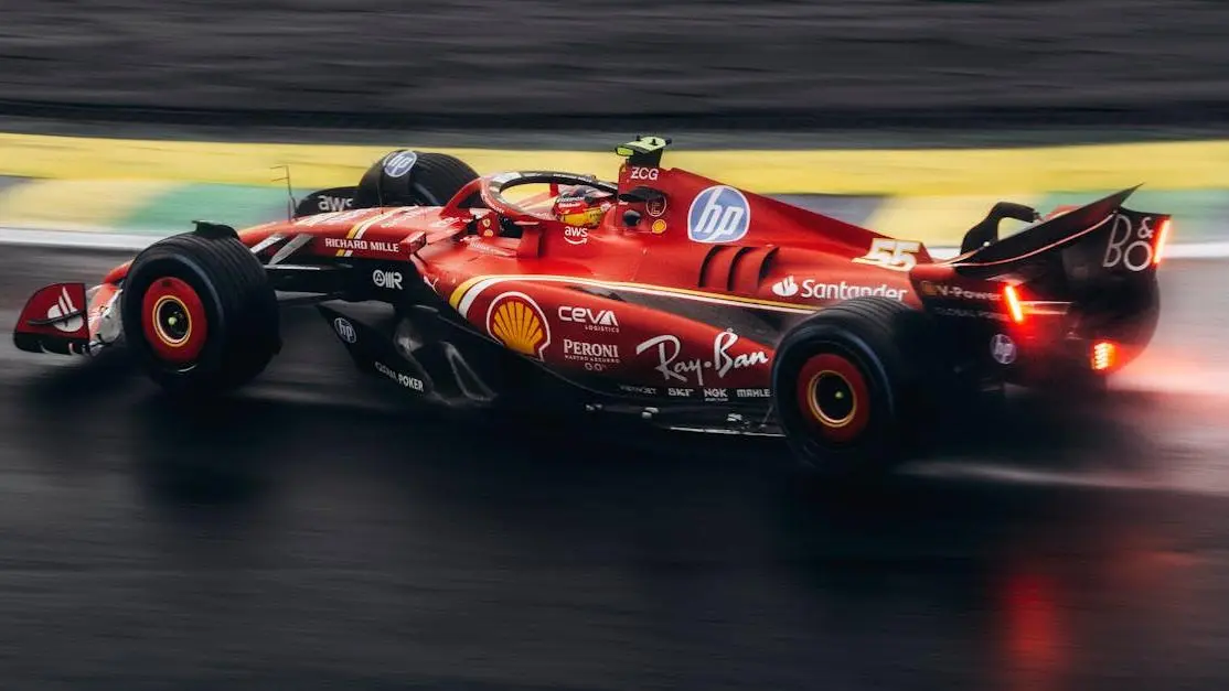 Formula 1 rear wing car racing on wet track, demonstrating aerodynamic design and performance.