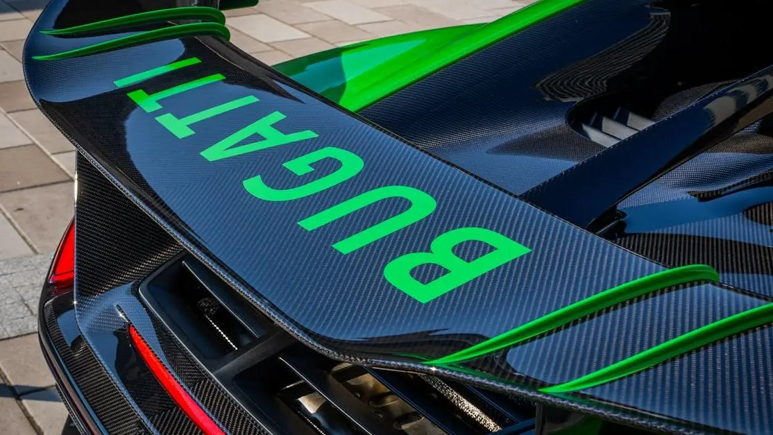 Carbon fiber spoilers with branded logo on car in urban setting