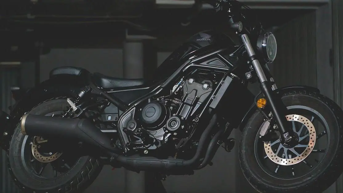 Black Honda motorcycle in industrial garage highlighting mechanics, related to Motus aftermarket parts