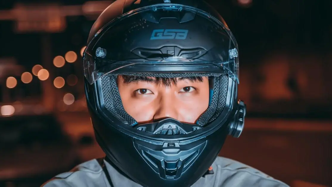 Close-Up Of A Man Wearing An Auto Racing Helmet At Night, Highlighting Safety And Performance
